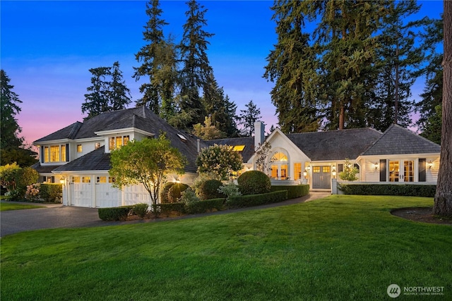 shingle-style home with a yard, french doors, driveway, and a chimney