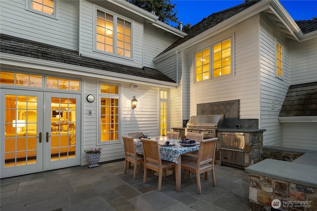 view of patio featuring outdoor dining space, grilling area, area for grilling, and french doors