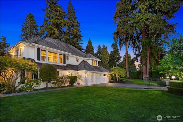 view of front of house featuring driveway, fence, and a front yard