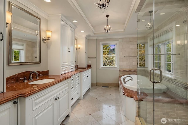 bathroom with crown molding, a wealth of natural light, a raised ceiling, and a sink