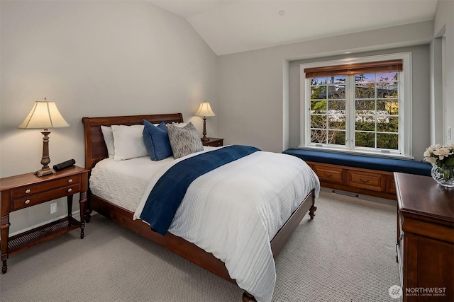 bedroom with lofted ceiling, visible vents, and light colored carpet