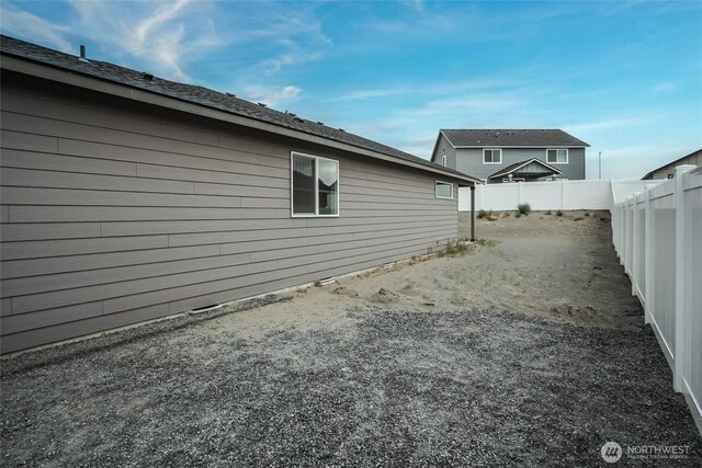 view of side of home featuring a fenced backyard