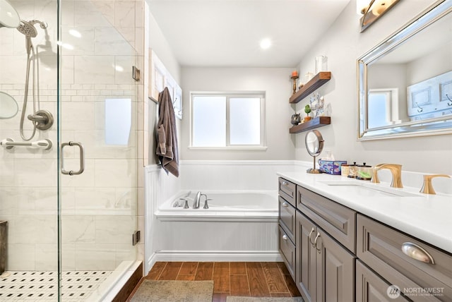 bathroom featuring separate shower and tub, hardwood / wood-style flooring, and vanity