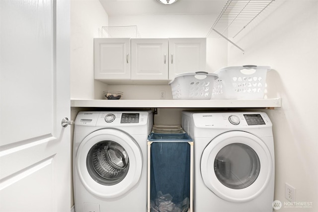 clothes washing area featuring cabinets and washer and dryer