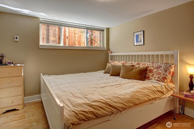 bedroom with light wood-style floors and baseboards