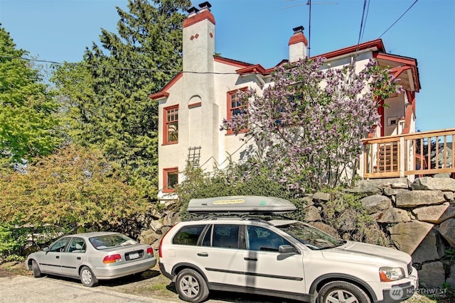 view of side of home featuring a chimney