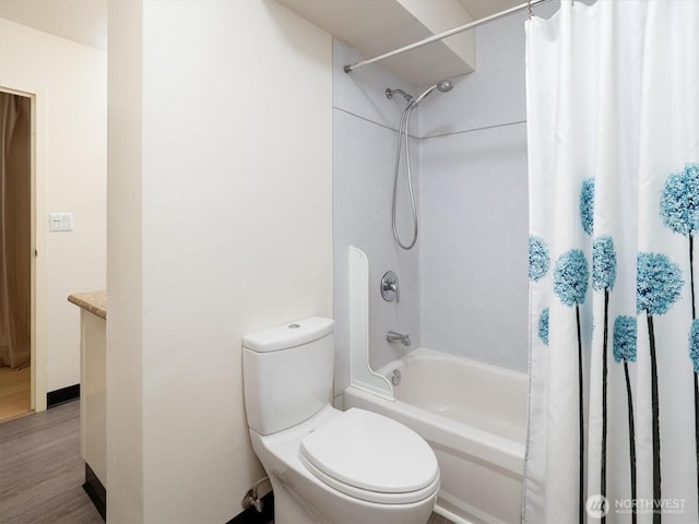 full bathroom featuring vanity, hardwood / wood-style floors, toilet, and shower / bath combo with shower curtain