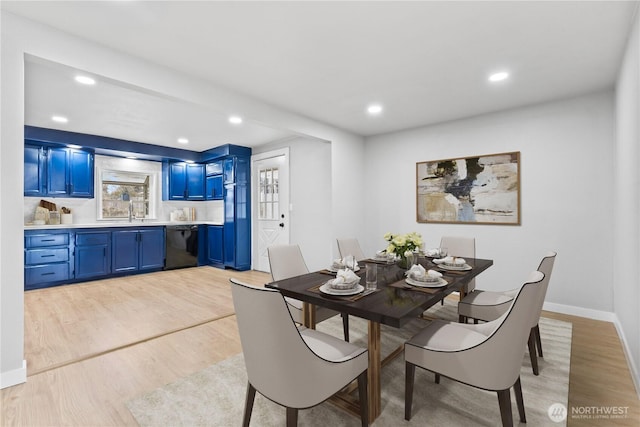 dining area with light hardwood / wood-style floors and sink