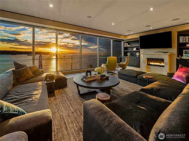 living room featuring a water view and built in shelves