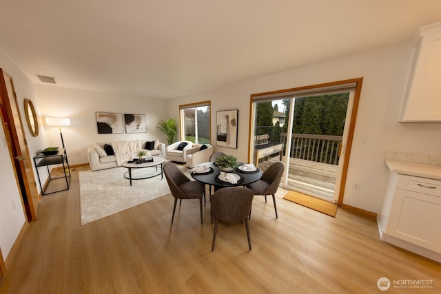 dining space with light hardwood / wood-style flooring