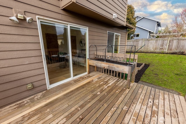 wooden terrace featuring a lawn