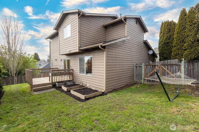 back of house featuring a yard and a deck