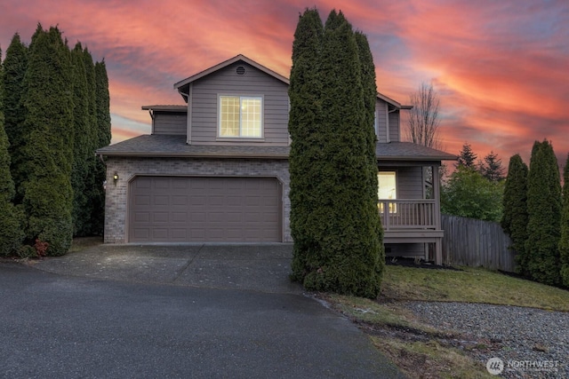 view of front of home featuring a porch and a garage