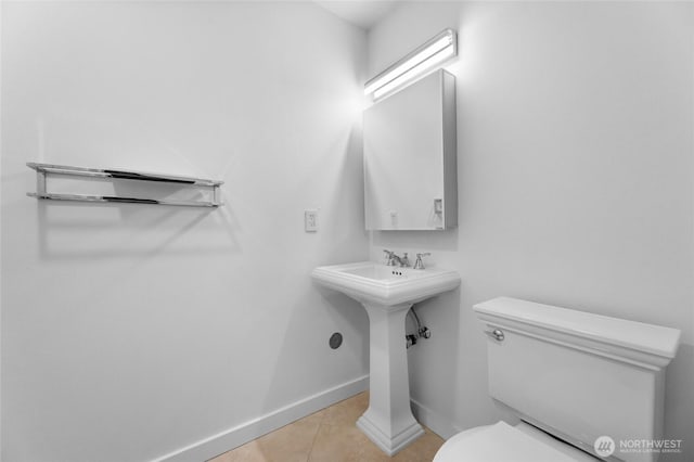 bathroom featuring toilet and tile patterned flooring