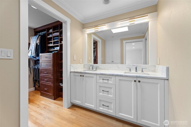 bathroom featuring ornamental molding, vanity, and hardwood / wood-style floors