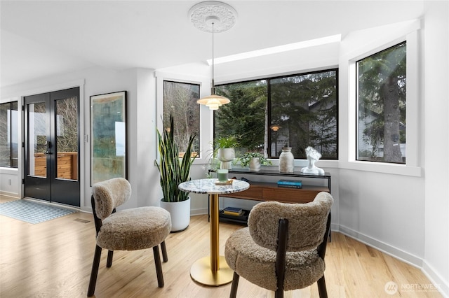 living area featuring plenty of natural light and light hardwood / wood-style floors