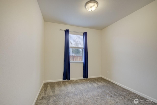 carpeted empty room with baseboards