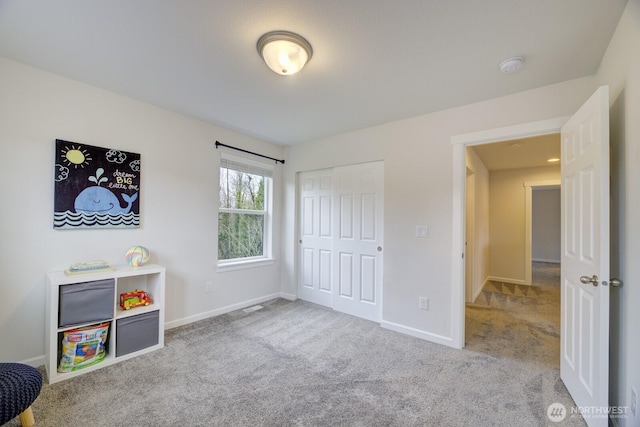 bedroom featuring a closet, baseboards, and carpet flooring