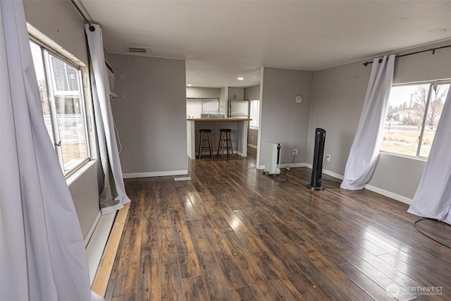 unfurnished living room featuring dark wood-type flooring