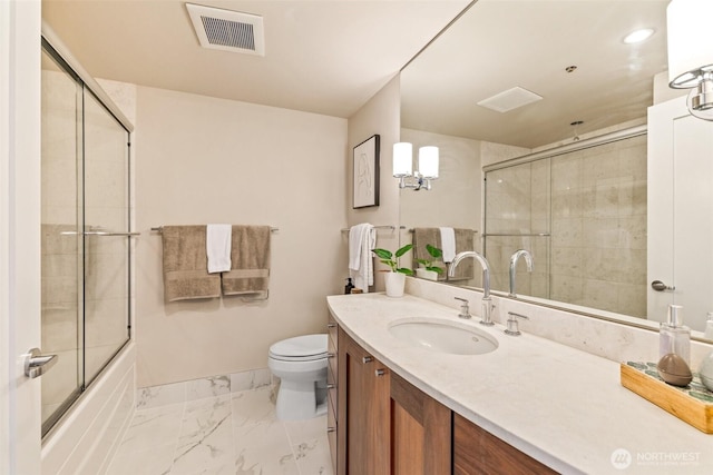 full bathroom with toilet, vanity, and enclosed tub / shower combo