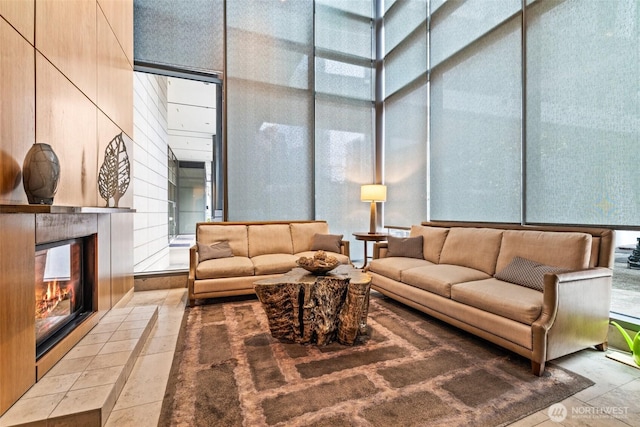 living room with a wall of windows and a towering ceiling