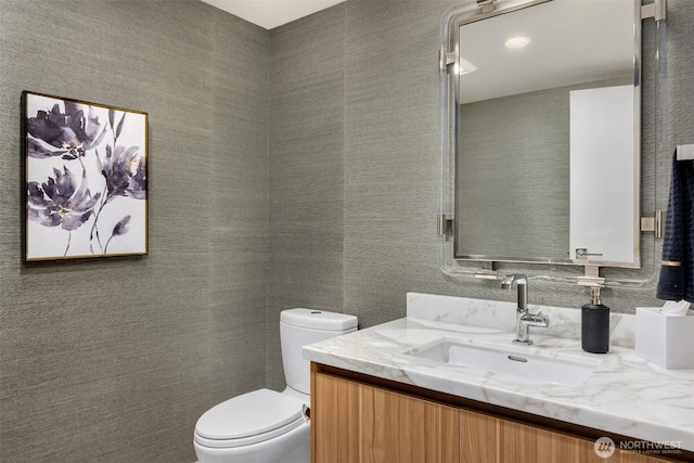 bathroom with toilet and vanity