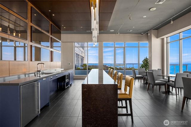 kitchen with a kitchen island, plenty of natural light, a water view, and a sink