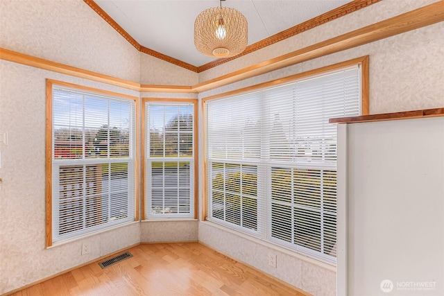 unfurnished sunroom featuring vaulted ceiling