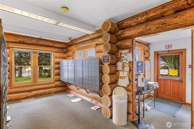 interior space with carpet flooring and a mail area