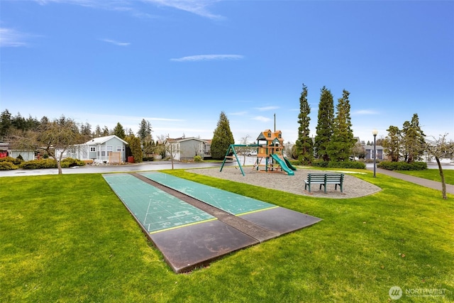 view of jungle gym featuring a lawn