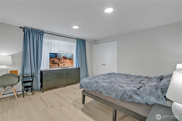 bedroom with light wood-style floors and recessed lighting