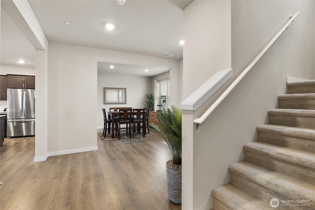 staircase with hardwood / wood-style flooring