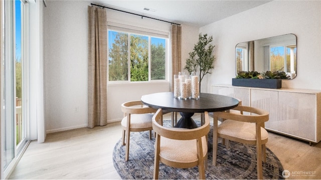 dining space featuring light wood-type flooring