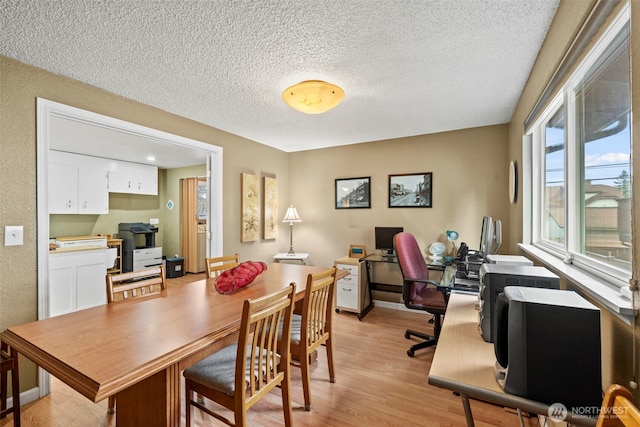 office featuring light wood-style floors and a textured ceiling