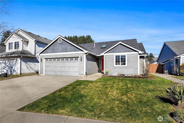 ranch-style house featuring a front yard, fence, driveway, roof with shingles, and a garage