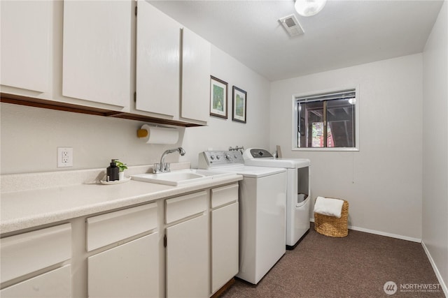 laundry area with washing machine and clothes dryer, sink, dark colored carpet, and cabinets