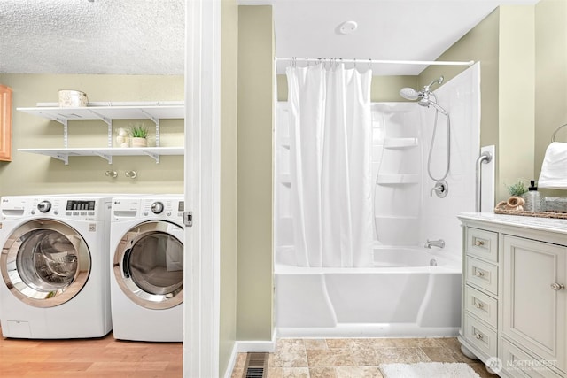 laundry area featuring washer and dryer and a textured ceiling