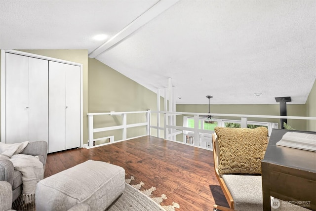 sitting room with lofted ceiling with beams and dark hardwood / wood-style floors