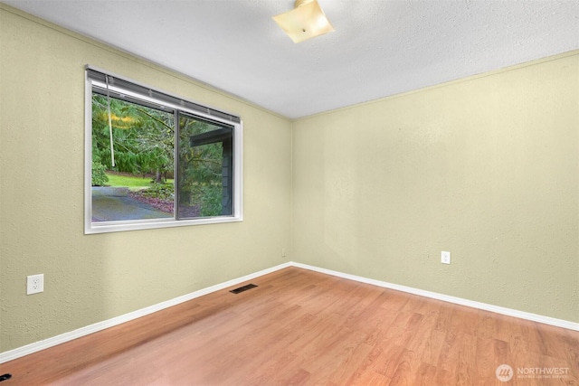 spare room with hardwood / wood-style floors