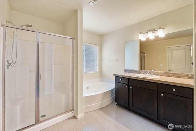 bathroom featuring vanity, a garden tub, tile patterned flooring, and a stall shower