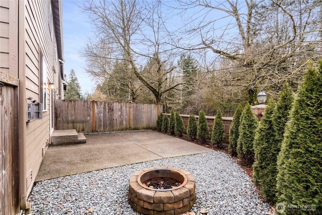 view of patio / terrace with a fenced backyard and an outdoor fire pit