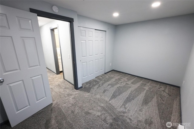 unfurnished bedroom with carpet, a closet, and recessed lighting