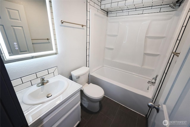 bathroom featuring shower / washtub combination, vanity, toilet, and tile patterned floors