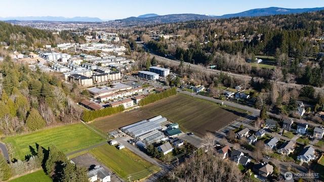 aerial view with a wooded view and a mountain view