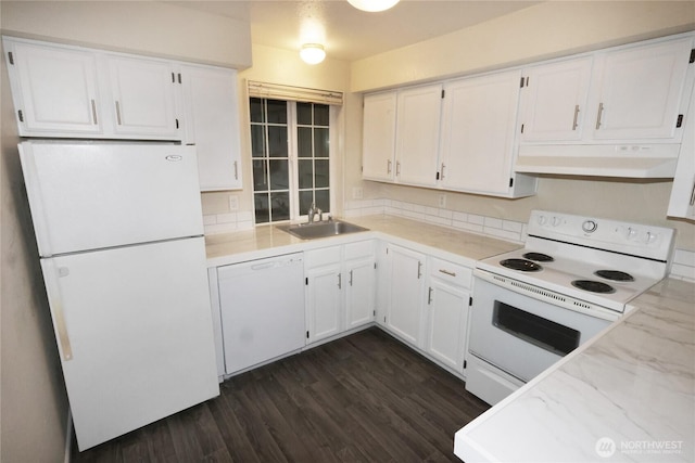 kitchen with white appliances, white cabinetry, a sink, and under cabinet range hood