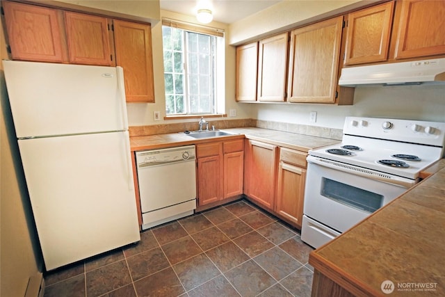 kitchen with white appliances, tile counters, under cabinet range hood, a baseboard heating unit, and a sink