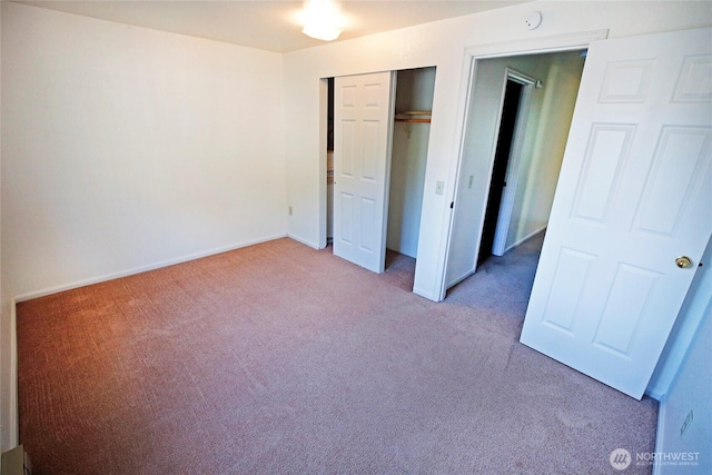 unfurnished bedroom with baseboards, a closet, and light colored carpet