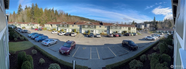 view of property's community with uncovered parking and a residential view