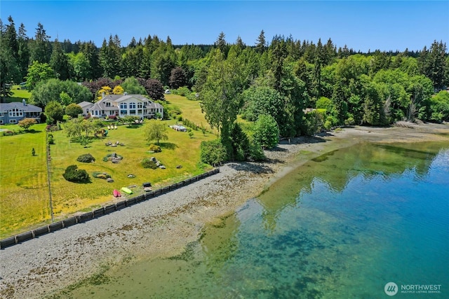 birds eye view of property with a water view and a view of trees