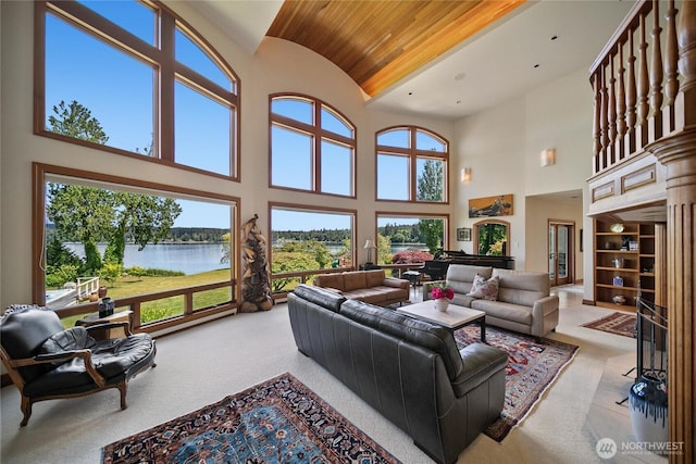 living room with a water view, wooden ceiling, plenty of natural light, and lofted ceiling